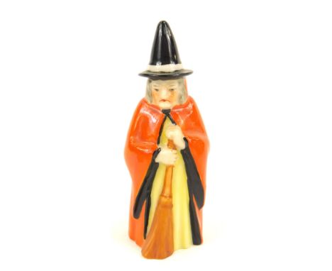 A Royal Worcester porcelain candle snuffer, circa 1923, modelled as a witch, printed mark. 