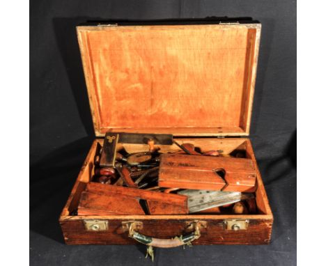 A wooden case containing vintage tools