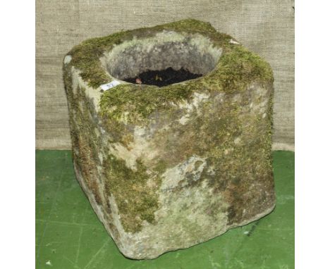 A square antique stone trough.