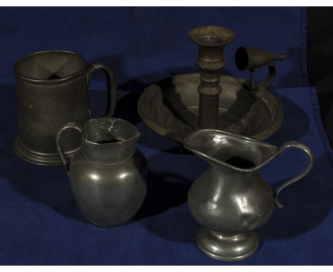 A pewter candlestick, two jugs and a tankard