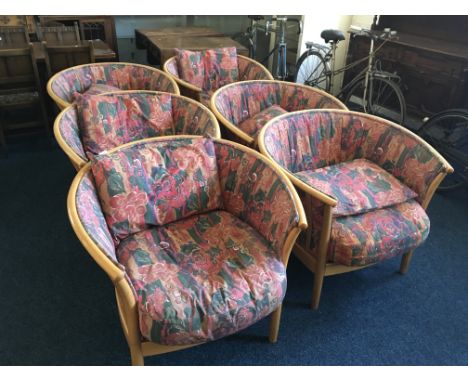 A set of six Ercol reception armchairs with floral cushions