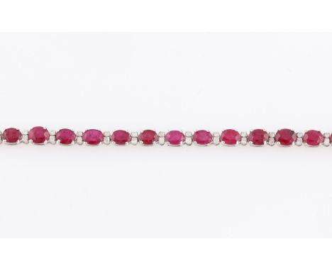 A contemporary ruby and diamond line bracelet, set with 27 sapphires, each measuring approx. 5x4mm, with two round brilliant 