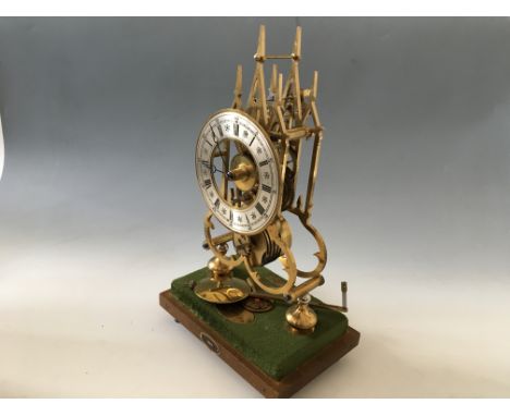 A brass fuse movement, gothical style skeleton clock in Perspex cabinet, made by Arnold Clarke, exhibitioned, in 1983.