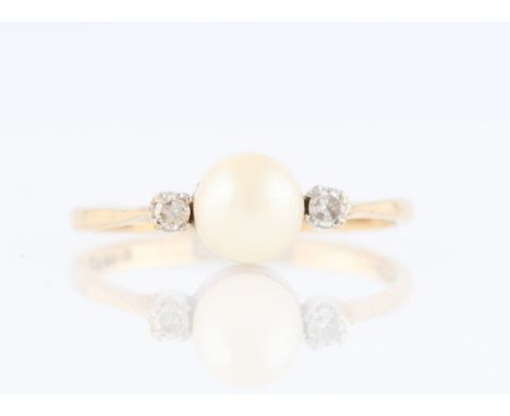 A 9ct yellow gold pearl and diamond three stone ring, set with a central pearl flanked to either side with an eight-cut diamo