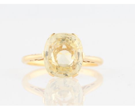 A yellow sapphire single stone ring, set with an oval cut yellow sapphire, measuring approx. 10x9mm, set in indistinctly stam