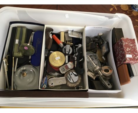 A plastic box containing pens, cigarette lighter, pen knives, compacts, spoons etc.
