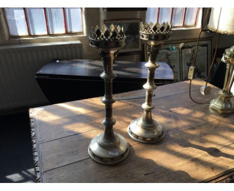 A pair of gothic style, silver finished candlestick holders with crown design to top.