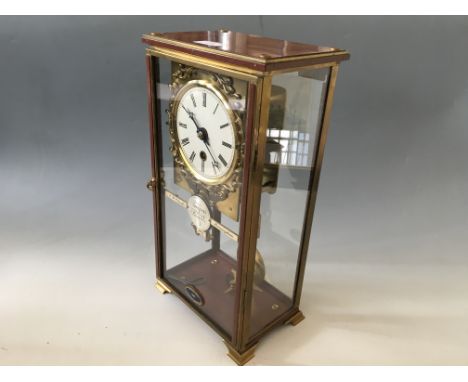 A clock by Arnold Clarke with fuse chain movement in cabinet