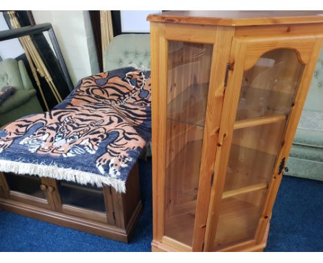 A pine glazed corner cabinet, corner TV video cabinet and patterned oblong rug.