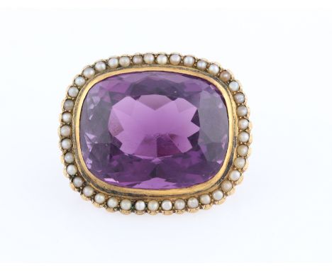 An amethyst and seed pearl brooch, set with a cushion cut amethyst measuring approx. 23x18mm, surrounded by a border of seed 