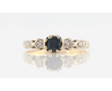 An 18ct yellow gold sapphire and diamond ring, set with a central square cut sapphire, flanked to either side with an eight-c