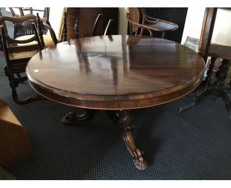 Rosewood tilt top dining table on tripod base together with four chairs