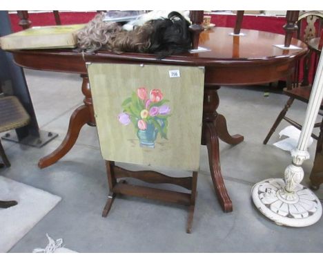 A hand painted fire screen table