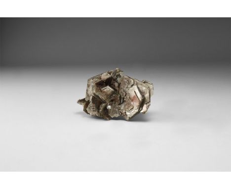 A finely formed cluster of flat, hexagonal muscovite crystals in white card tray with label reading: 'MUSCOVITE, Minas Gerias