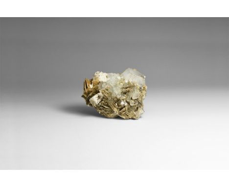 A cluster of pale blue, very well-formed, lustrous aquamarine crystals on matrix, with accessory muscovite; in old white card