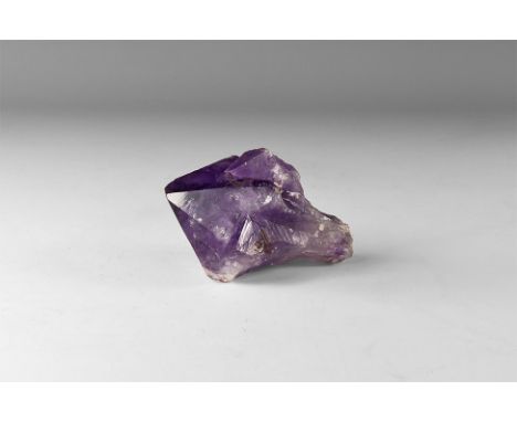 A dark purple and white amethyst specimen in white card tray with label reading: 'AMETHYST, Rio Grande do Sul, Brazil'. 271 g