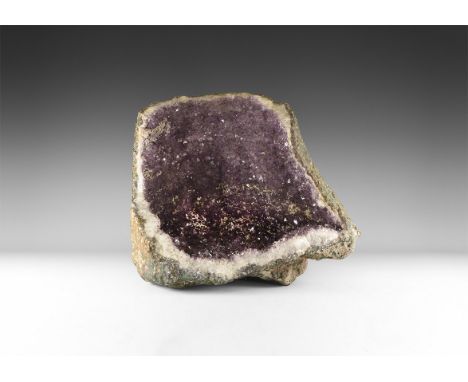 A fine amethyst 'throne' geode, with richly coloured amethyst crystals layered over rock crystal. 24.3 kg, 39.5cm tall (15 1/