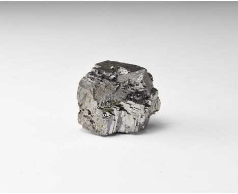 A piece of galena with interlocking and stepped cube-shaped crystals, in white card tray with label reading: GALENA, Tri-Stat