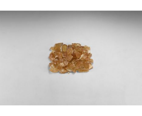 A group of fifty pale brown calcite specimens from Mexico. 532 grams total, 21-45mm (3/4 - 1 3/4"). From the historic ‘Victor