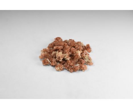 A group of fifty red aragonite 'sputnik' specimens, each formed from several pseudohexagonal crystals; from Morocco. 412 gram