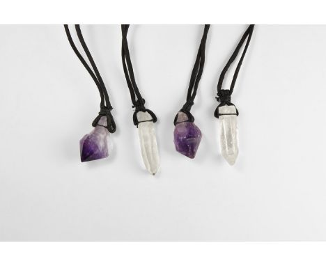 A group of four large crystals pendants mounted on a black thick string, comprising of two purple amethyst and two transparen