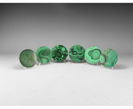 A group of six cut and polished circular malachite coasters with pale and dark green banding. 446 grams, 76mm (3"). From the 