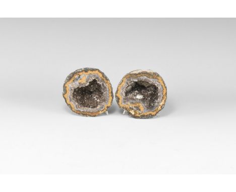 A pair of cut and polished geode with bands of orange and purple agate, amethyst crystals to the centre.  524 grams total, 81