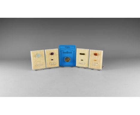 A mixed group of four display frames with fabric basis and an example of raw and cut mineral sample, including aquamarine, am
