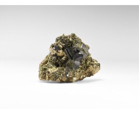 An unusually fine group of sharply formed, deep green epidote crystals with quartz on a rock groundmass, from the famous Gree