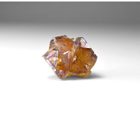 A fine orange and purple fluorite specimen in white card tray with label reading: 'FLUORITE, Tri-State, USA'. 62 grams, 37mm 