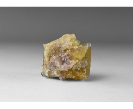 A fluorite specimen consisting of purple and yellow crystals, in old white card tray with text 'FLUORITE, Tri-State (Miller C