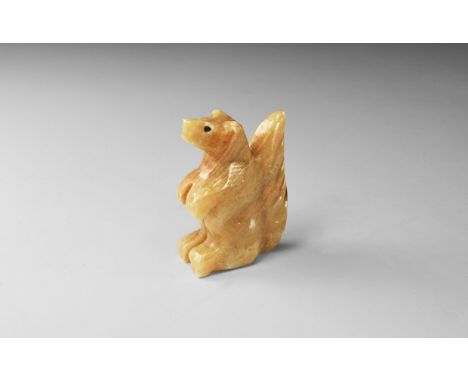 A carved statuette of a seated squirrel from a brown banded onyx; with label 'Made in Mexico'. 107 grams, 66mm (2 1/2"). From