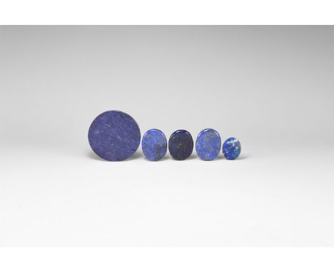 A group of five polished lapis lazuli slices, one circular and four oval. 81 grams total, 30-62mm (1 1/4 - 2 1/4"). From the 