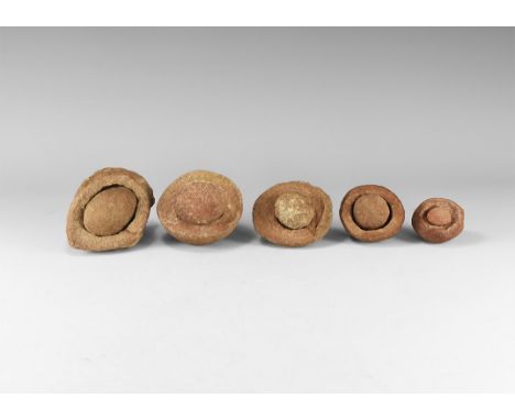 Group of five wind-rounded pebbles with their individual hollowed out 'nests', from the Kalahari Desert region, western Afric