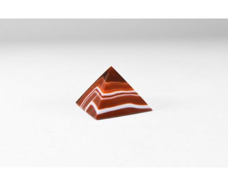 A very finely carved polished banded agate pyramid in deep red and brown, colour enhanced. 43 grams, 40mm (1 1/2"). From the 