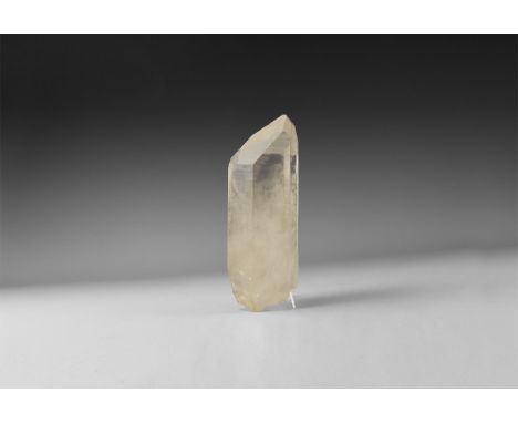A large transparent pointed hexagonal quartz crystal. 986 grams, 18.5cm (7 1/4"). From the historic ‘Victorian Museum’ and la