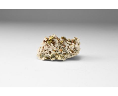 A specimen consisting of tetrahedrite crystals on pale pink dolomite, in white card tray with label reading: 'TETRAHEDRITE on