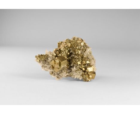 A stunning specimen of well-crystallised milky quartz crystals on lustrous cubic pyrite crystals from Peru, in old white card