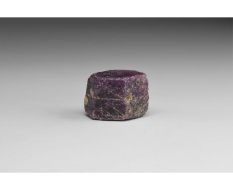 A fine specimen of dark purple hexagonal ruby, in white card tray with label reading: 'RUBY, Mysore, India'. 20 grams (100 ca
