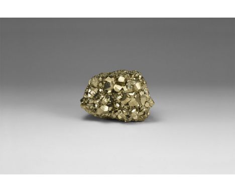 An exceptional specimen of pyrite crystals exhibiting pyritohedral forms, in white card tray with label reading: 'PYRITE, Hua