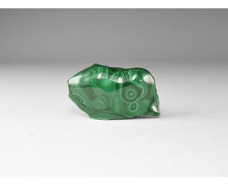 A cut and polished malachite specimen, with concentric circles of dark and pale green. 58 grams, 70mm (2 3/4"). From the hist