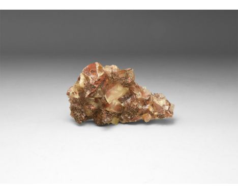 A fine specimen of translucent calcite and dark orange sphalerite crystals, in a white card box with label reading: 'CALCITE 