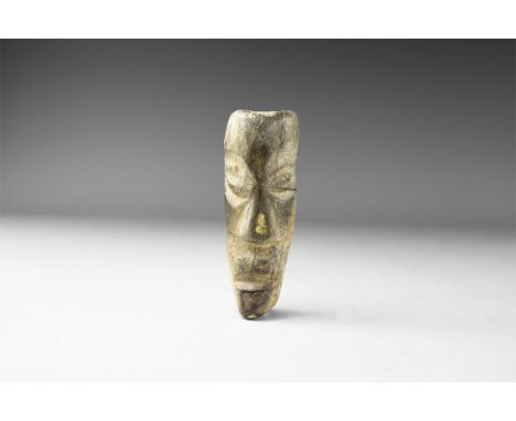 Pliocene Period, 5.2-2.5 million years BP. A mastodon fossil bone with later carving from Java. 105 grams, 10.5cm (4"). From 