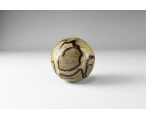 A fine sphere carved from a septarian concretion, with yellow and brown calcite, including a hollow filled with yellow calcit