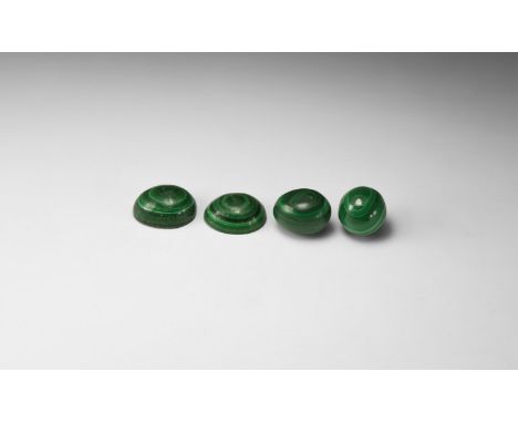 A group of four malachite carvings comprising of egg, sphere and two egg halves. 86 grams total, 22-30mm (3/4 - 1 1/4"). From