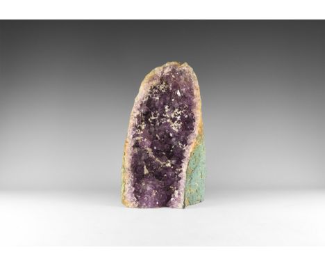 A fine amethyst 'cathedral' geode, with richly coloured amethyst crystals layered over rock crystal. 9.7 kg, 34.5cm (13 1/2")