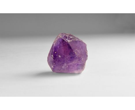 A fine specimen of dark purple amethyst crystal in white card box with label reading: 'AMETHYST, Rio Grande do Sul, Brazil'. 