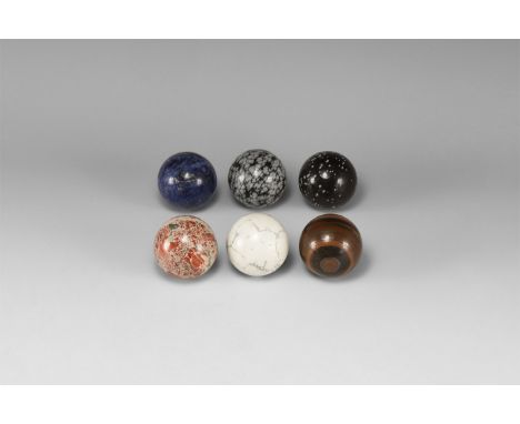 A group of six polished spheres comprised of: snowflake obsidian (2), agate, tiger eye, sodalite and marble. 558 grams total,
