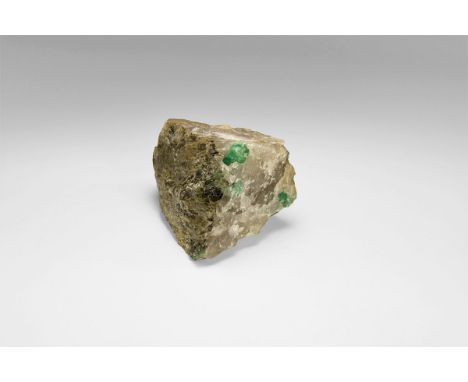 An emerald crystal in quartz, from Brazil, with one prominent emerald and several smaller, less prominent emeralds, the quart