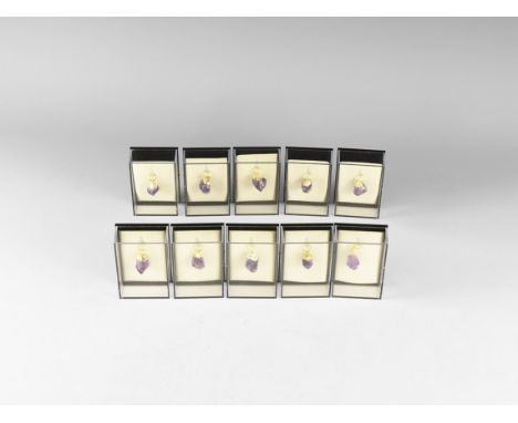 A group of ten deep purple amethyst crystal pendants with gold-coloured metal caps, all in plastic presentation boxes. 153 gr